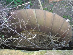 Looking into one of two riveted iron containers.