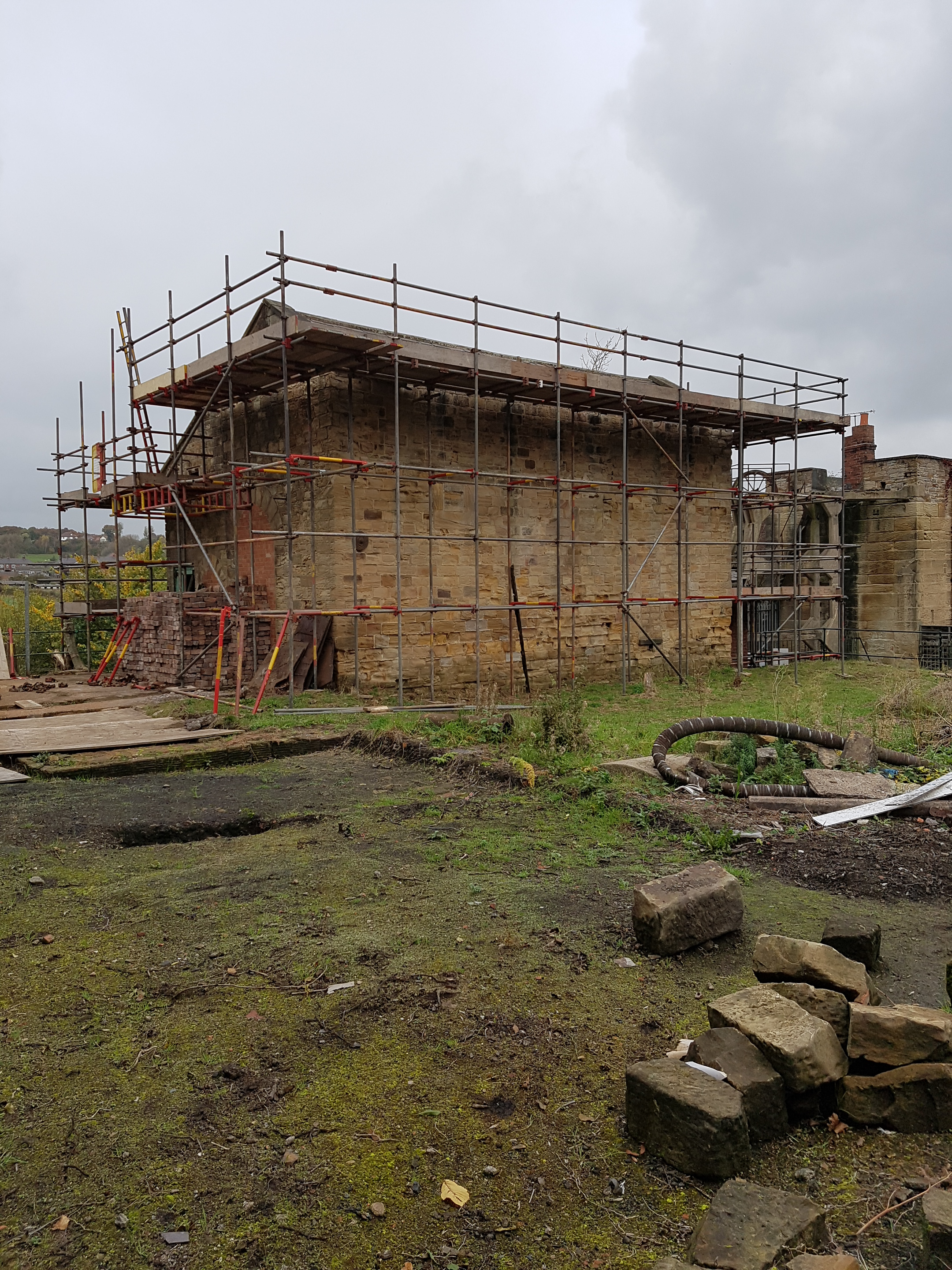 Image of winding engine house before roof restoration (scaffolded and damaged roof)