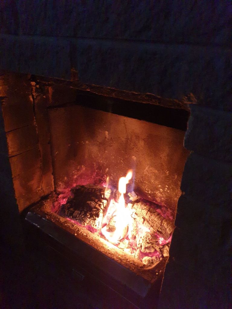 View of red burning fire in Pump House Cottage