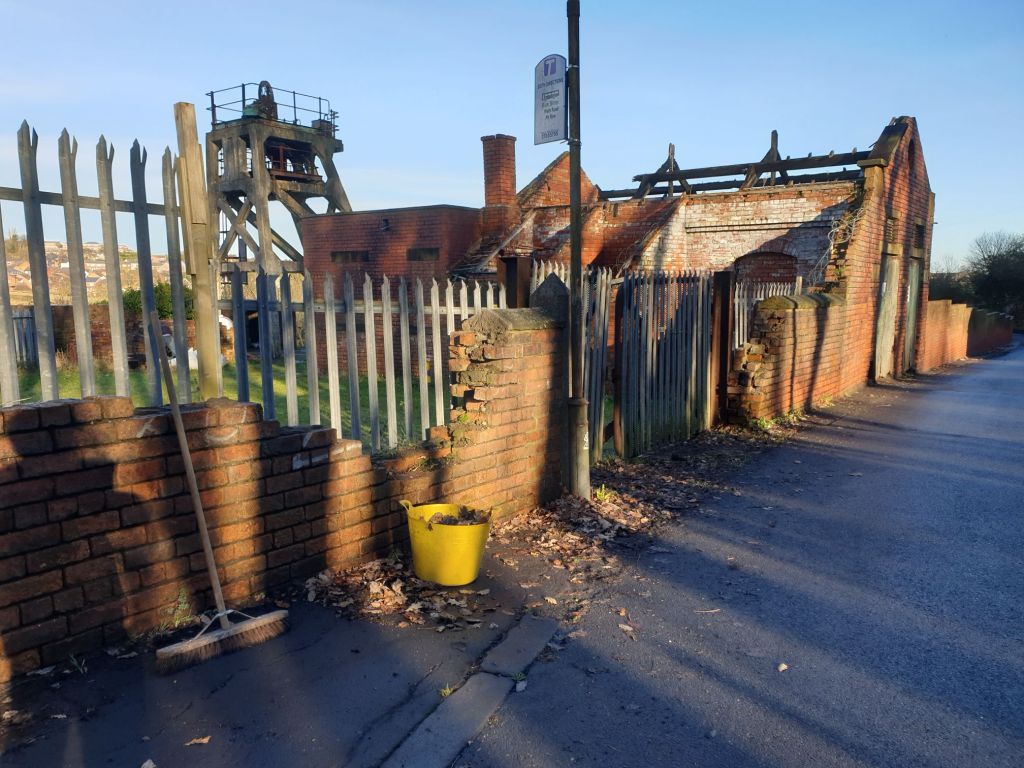 External view of the colliery site from Wath Road, showing brush and tub containing swept up leaves