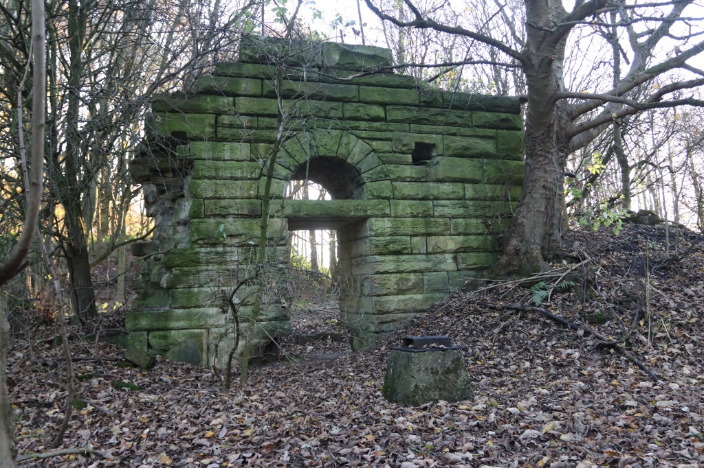 View of surviving ruined engine house archive in a woodland setting. Formerly engine house of Flockton Lane End
